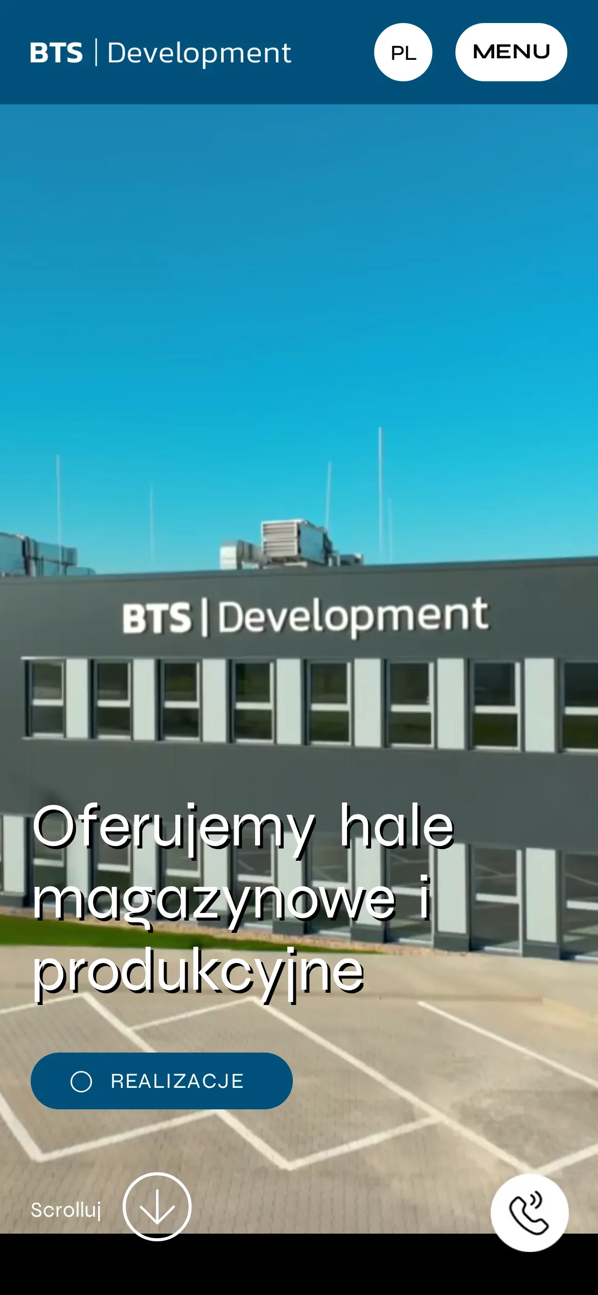 Strona główna BTS Development na telefonie: kadr z filmu z biurowcem BTS Development, hasło „Oferujemy hale magazynowe i produkcyjne” i przycisk „Realizacje”
